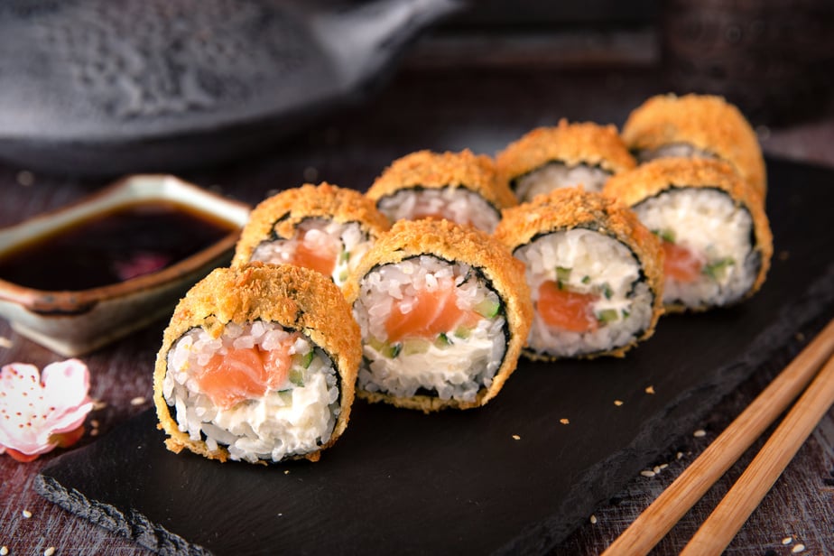 Hot fried Sushi Roll with salmon, avocado and cheese. Sushi menu.