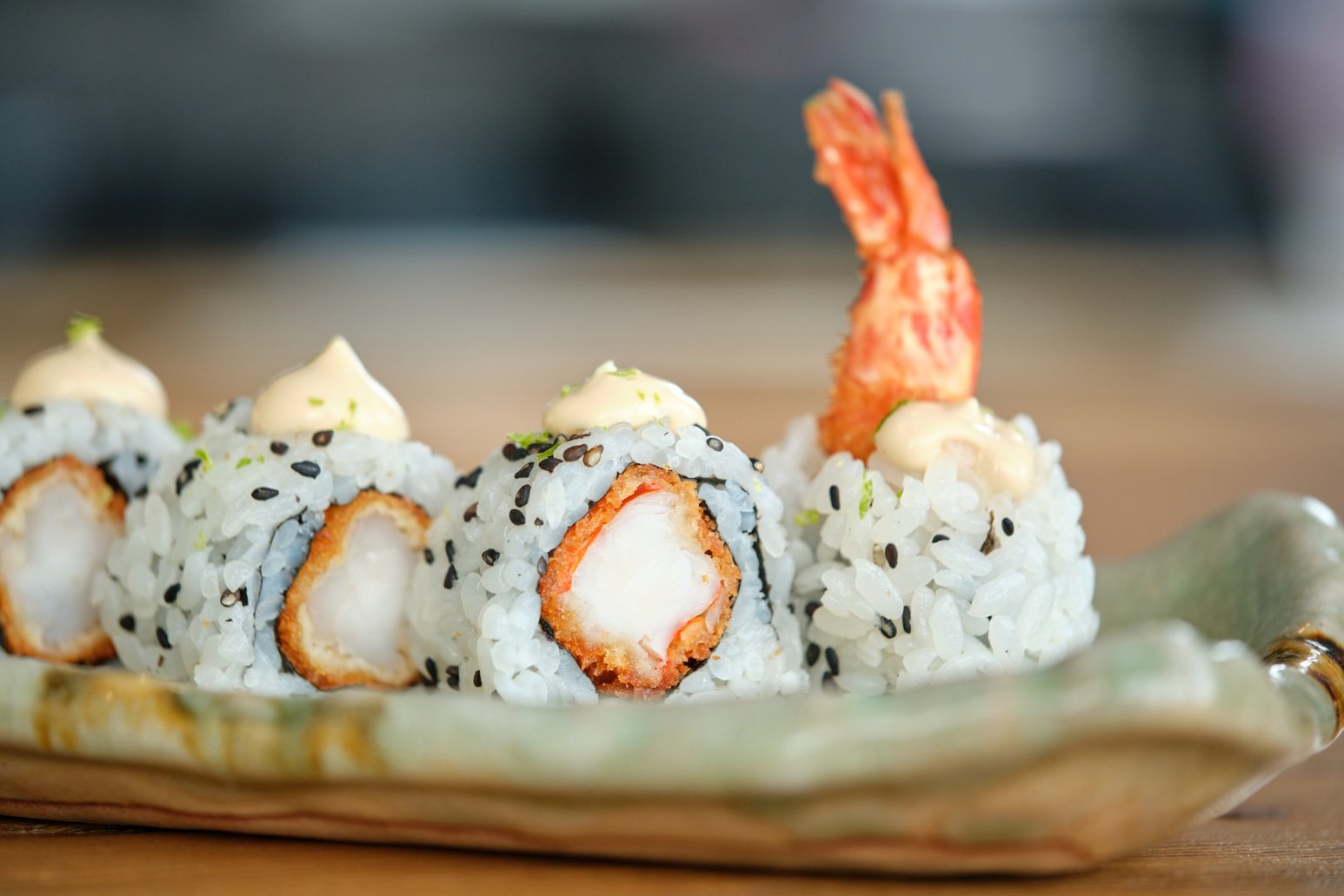 Delicious uramaki rolls served on plate